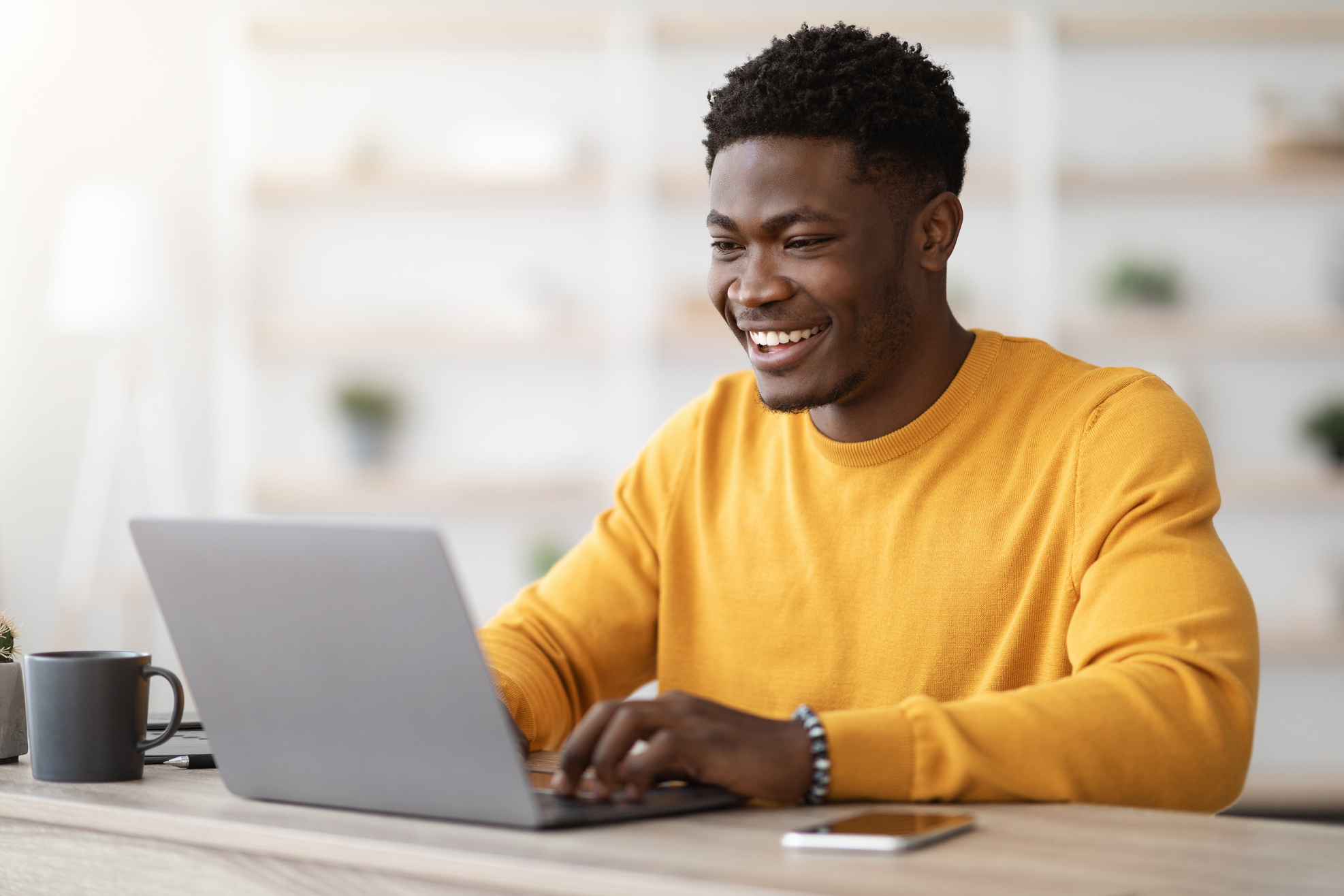 Male Project Manager Typing on Laptop